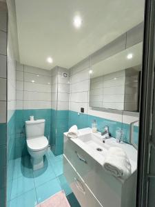 a bathroom with a white toilet and a sink at Appartement Duplex élégant et calme Marrakech Menara in Marrakesh