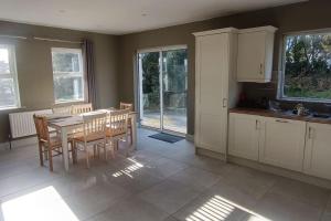 a kitchen with a table and chairs in a room at Harbor View in Valentia Island