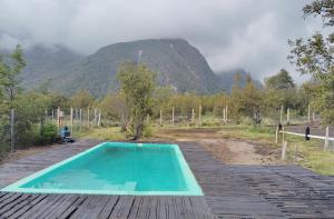 a swimming pool with a mountain in the background at Cabana Vista Nevada in Nevados de Chillan