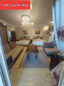 a living room with two beds and a couch at Resort altayar Villa altayar 2- Aqua Park in Sidi Kirayr