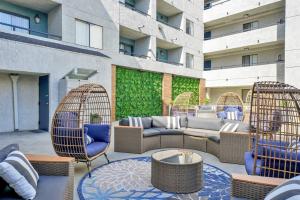 a patio with wicker chairs and a couch on a building at King Bed, Self-Checkin, Garage, WiFi - Your Dream Stay Near Disneyland! in Santa Ana
