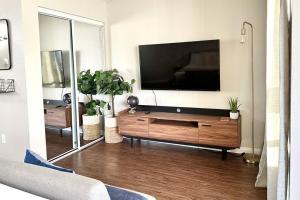 a living room with a large flat screen tv at King Bed, Self-Checkin, Garage, WiFi - Your Dream Stay Near Disneyland! in Santa Ana