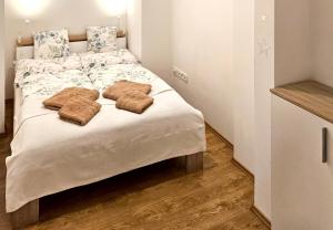 a bedroom with a bed with two pillows on it at Janka Apartment in Bratislava