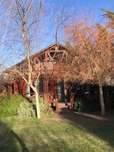 a brick house with a tree in front of it at Cabañas Iremía in Uribelarrea
