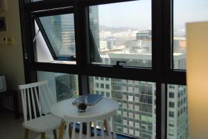 a table and chairs in a room with a window at Samsung Coex Daechi Gangnam House G in Seoul