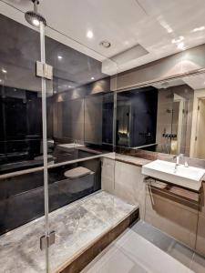 a bathroom with a sink and a glass shower at Soho West End in London