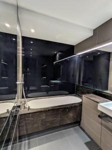 a bathroom with a tub and a sink at Soho West End in London
