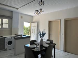 a kitchen and dining room with a table and chairs at Northern Pearl in Karousádes