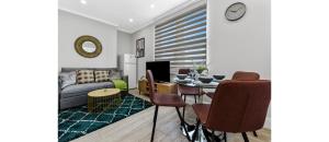 a living room with a couch and a table at Southwark Serenity: Cozy Flat with Balcony in London