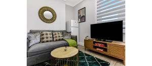 a living room with a couch and a flat screen tv at Southwark Serenity: Cozy Flat with Balcony in London