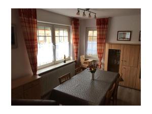 a kitchen with a table and two windows at Holiday home Seehase in Ekel