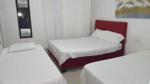 Postel nebo postele na pokoji v ubytování HOSTAL BARRANQUILLA INN