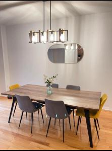 a dining room with a wooden table and chairs at Cozy home in Brampton (Mt pleasant Go station) in Brampton