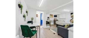 a room with a bed and a table and chairs at Cosy Little Flat - Perfect Base for Explorers in London