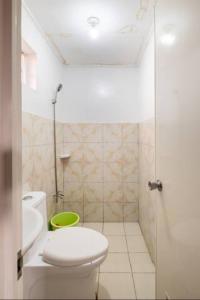 a bathroom with a toilet and a sink and a shower at SMyleINN camella Jade in Mexico