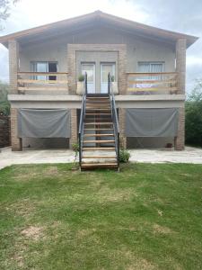 a house with a staircase in front of it at Complejo El Faro in Santa Rosa de Calamuchita +36 photos