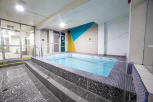 a large swimming pool in a building at HOTEL KALIXTO in Cayma