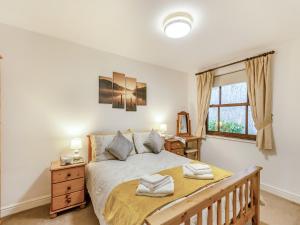 a bedroom with a large bed and a window at Kissing Gate in Keswick