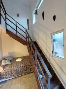 a bedroom with a bunk bed and a staircase at Urutau Loft in Puerto Iguazú