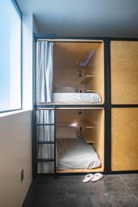 a bunk bed with two beds in a room at Haven Coliving in Los Angeles