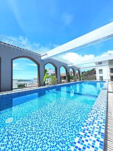 a large swimming pool with blue tiles on a building at RUBY 2 LUXURY VILLA by NEST GROUP in Nha Trang
