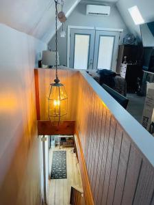 a room with a staircase with a chandelier and a room with a stair at Bastrop Tiny Disc Golf Retreat in Bastrop