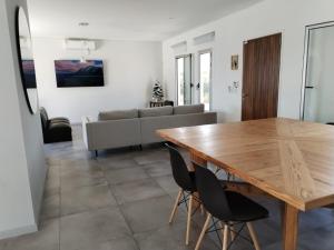 a living room with a wooden table and chairs at Casa de playa en jose ignacio uruguay. in José Ignacio