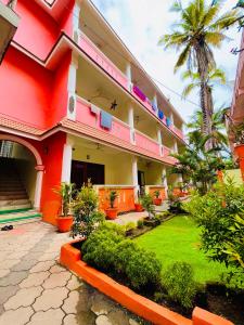 a building with a garden in front of it at Moon Valley Cottage in Kovalam