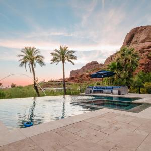 a swimming pool with palm trees and a mountain at Multi-Million Dollar Luxury Estate, Heated Pool, City Views in Phoenix