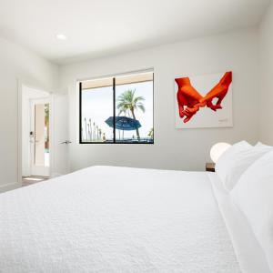 a white bedroom with a large bed and a window at Multi-Million Dollar Luxury Estate, Heated Pool, City Views in Phoenix