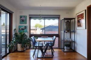 a dining room with a table and chairs and a window at Rose Cottage - Right in town in Healesville