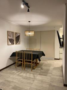 a dining room with a ping pong table and chairs at Duplex del Parque y Balneario in Necochea