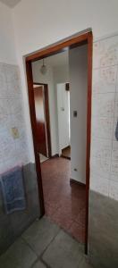 an empty hallway with a door open to a room at Casa Ana 3 departamento a 20 min del aeropuerto de ezeiza in Luis Guillón