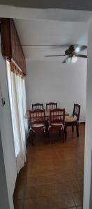 a dining room with a table and two chairs at Casa Ana 3 departamento a 20 min del aeropuerto de ezeiza in Luis Guillón