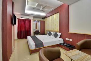 a hotel room with a bed and a tv at Townhouse 1307 Coastal Grand Hotels and Resorts in Coimbatore
