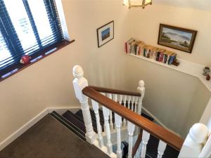 a stairway with a white stair railing and a stair case at Oak View Loft - Uk11926 in Lessingham