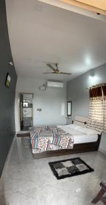a bedroom with a bed and a ceiling at Lee home stay in Hampi