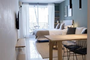 ブエノスアイレスにあるMagnolio Homely Apartmentのベッドルーム1室(ベッド1台、テーブル、窓付)