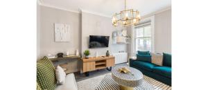 a living room with a couch and a table at Serenity in the City: Best 5BR Home in Whitechapel in London