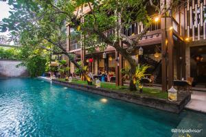 a pool of water in front of a building at The Elysian Boutique Villa Hotel in Seminyak
