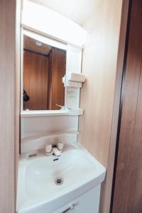 a bathroom with a white sink and a mirror at 北田辺 4階 in Osaka