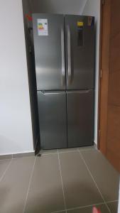 a stainless steel refrigerator in a kitchen at Departamento en Pucón, full equipado. in Pucón