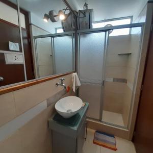 a bathroom with a sink and a shower at Hepico Departamentos Piura in Piura +81 photos