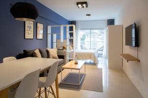 - un salon avec un lit et une salle à manger dans l'établissement Cedro Comfort Suite, à Buenos Aires