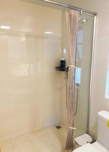 a shower in a bathroom with a shower curtain at Inn Yuiko in Dali
