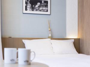 Postel nebo postele na pokoji v ubytování Hotel Gracery Ginza