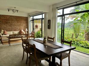 Rai Villa Colombo في كولومبو: غرفة معيشة مع طاولة وكراسي خشبية