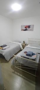 two beds sitting next to each other in a room at Apto vacacional DENIS T in Tunja
