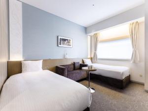 Postel nebo postele na pokoji v ubytování Hotel Gracery Ginza