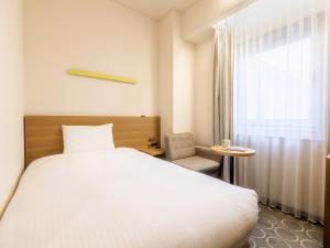 Postel nebo postele na pokoji v ubytování Hotel Gracery Ginza